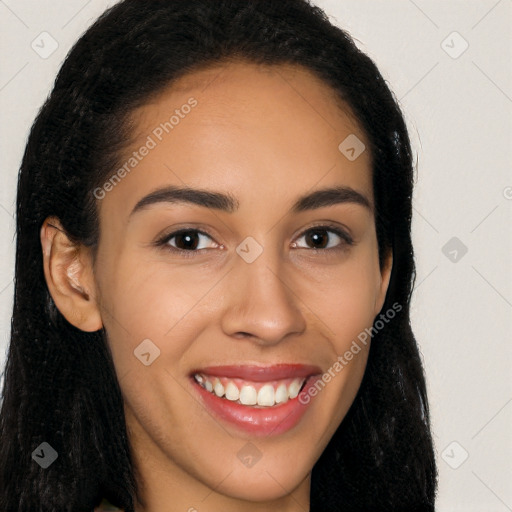 Joyful latino young-adult female with long  brown hair and brown eyes