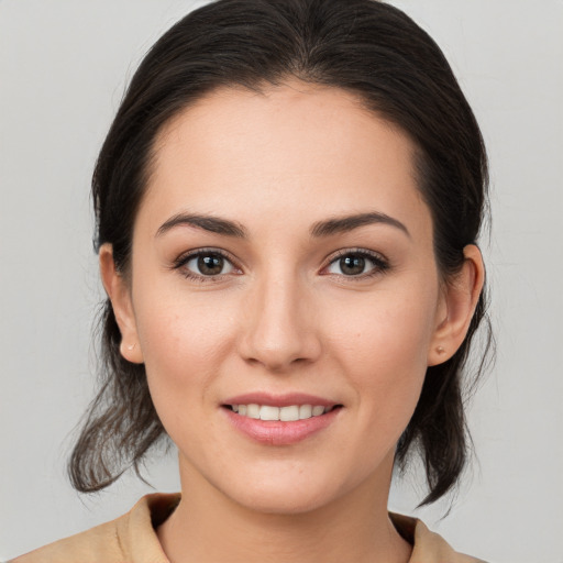 Joyful white young-adult female with medium  brown hair and brown eyes