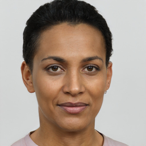 Joyful latino young-adult female with short  black hair and brown eyes