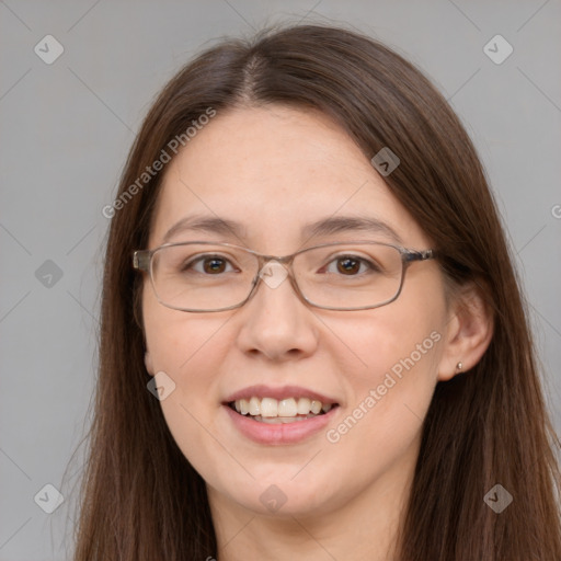 Joyful white adult female with long  brown hair and grey eyes