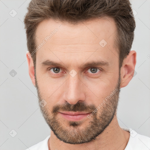 Joyful white adult male with short  brown hair and brown eyes