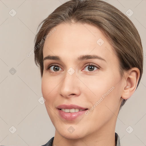 Joyful white young-adult female with medium  brown hair and brown eyes