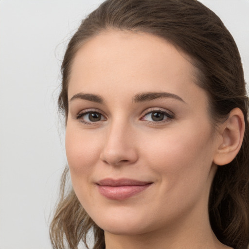 Joyful white young-adult female with long  brown hair and grey eyes