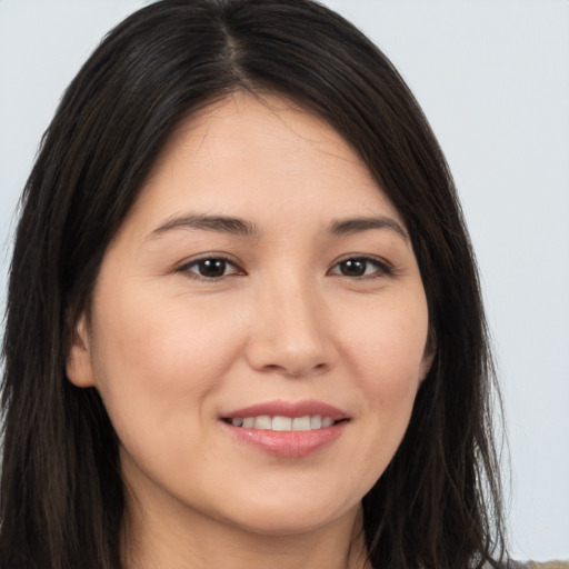 Joyful white young-adult female with long  brown hair and brown eyes