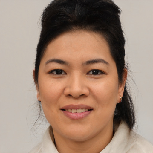 Joyful asian young-adult female with medium  brown hair and brown eyes
