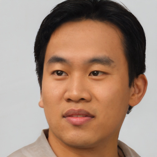 Joyful asian young-adult male with short  black hair and brown eyes