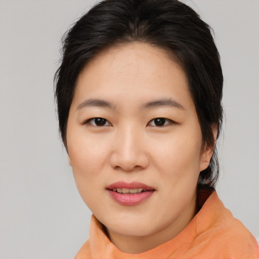 Joyful asian young-adult female with medium  brown hair and brown eyes