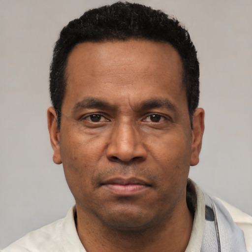 Neutral latino adult male with short  black hair and brown eyes