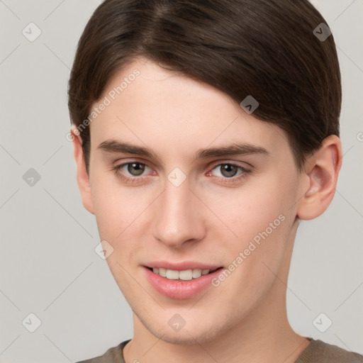 Joyful white young-adult male with short  brown hair and brown eyes