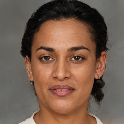 Joyful latino adult female with short  brown hair and brown eyes