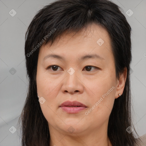 Joyful white adult female with long  brown hair and brown eyes