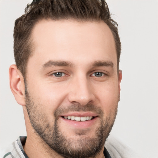 Joyful white young-adult male with short  brown hair and brown eyes