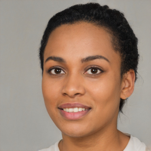 Joyful latino young-adult female with short  black hair and brown eyes