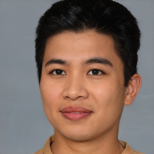 Joyful asian young-adult male with short  brown hair and brown eyes
