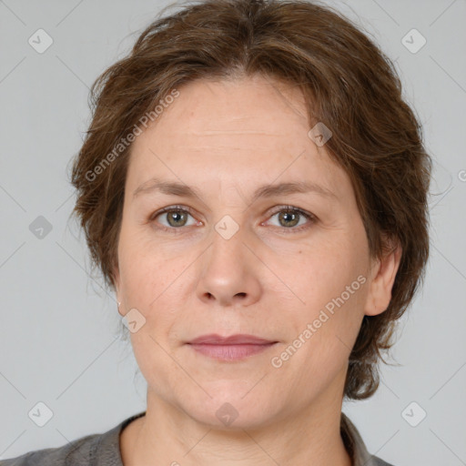 Joyful white adult female with short  brown hair and grey eyes