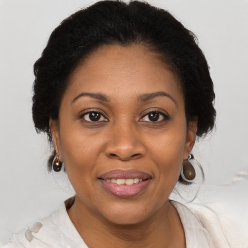 Joyful black adult female with medium  brown hair and brown eyes