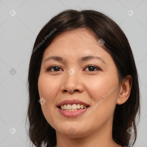 Joyful asian young-adult female with medium  brown hair and brown eyes