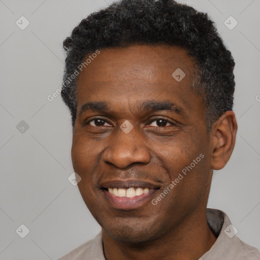 Joyful black adult male with short  black hair and brown eyes