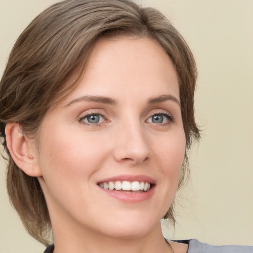 Joyful white young-adult female with medium  brown hair and blue eyes