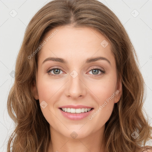 Joyful white young-adult female with long  brown hair and green eyes