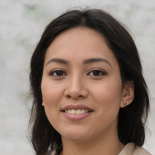 Joyful latino young-adult female with long  brown hair and brown eyes