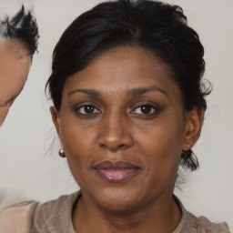 Joyful black adult female with short  brown hair and brown eyes