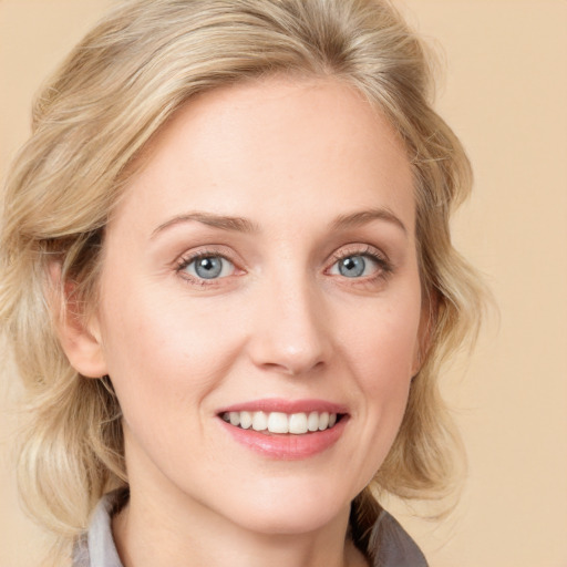 Joyful white young-adult female with medium  blond hair and blue eyes