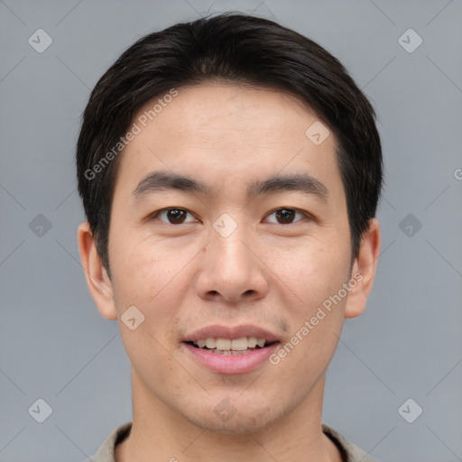 Joyful asian young-adult male with short  brown hair and brown eyes