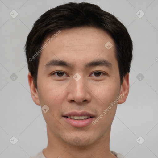 Joyful asian young-adult male with short  brown hair and brown eyes