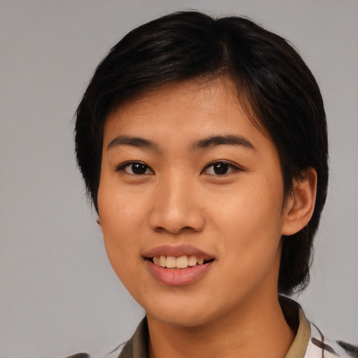 Joyful asian young-adult female with medium  black hair and brown eyes