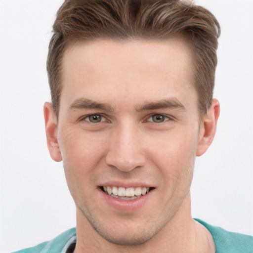 Joyful white young-adult male with short  brown hair and grey eyes