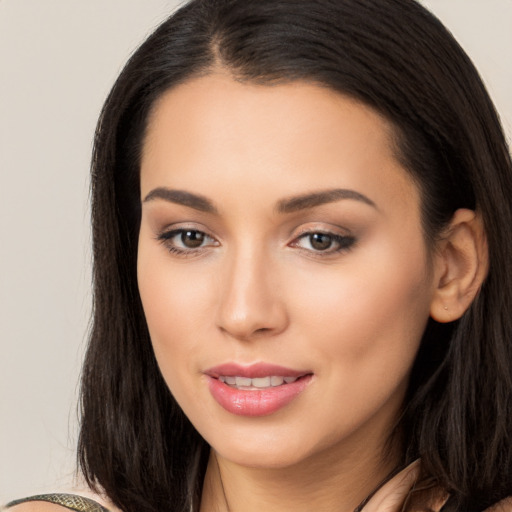 Joyful latino young-adult female with long  brown hair and brown eyes