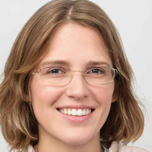 Joyful white young-adult female with medium  brown hair and blue eyes