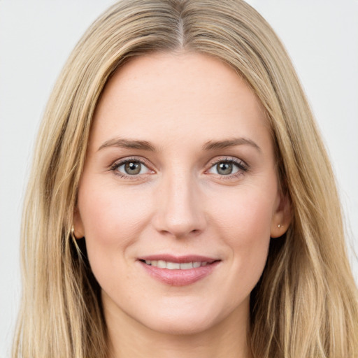 Joyful white young-adult female with long  brown hair and green eyes