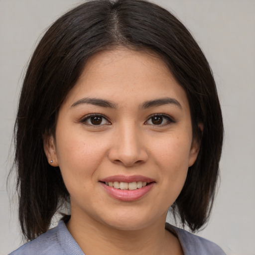 Joyful asian young-adult female with medium  brown hair and brown eyes