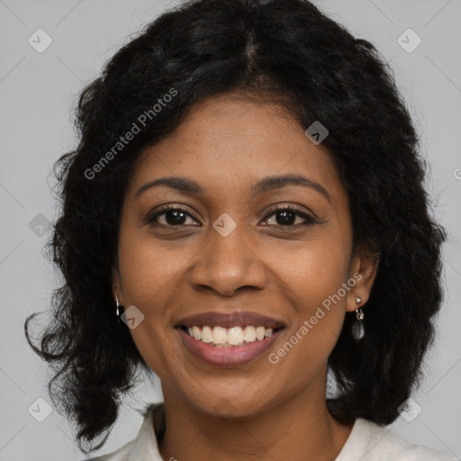 Joyful black young-adult female with long  black hair and brown eyes