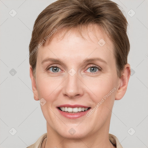 Joyful white young-adult female with short  brown hair and grey eyes