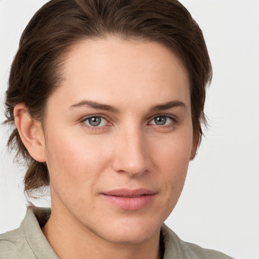 Joyful white young-adult female with short  brown hair and grey eyes