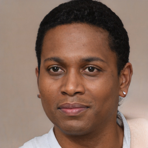 Joyful black young-adult male with short  black hair and brown eyes