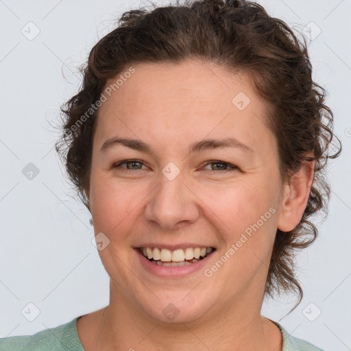 Joyful white young-adult female with medium  brown hair and green eyes