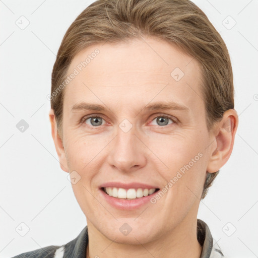 Joyful white adult female with short  brown hair and grey eyes