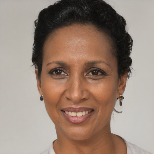 Joyful black adult female with short  black hair and brown eyes