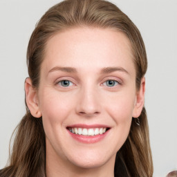 Joyful white young-adult female with long  brown hair and blue eyes