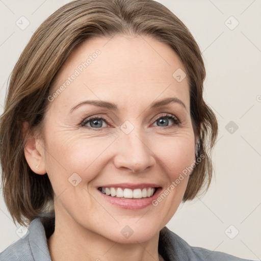 Joyful white adult female with medium  brown hair and grey eyes