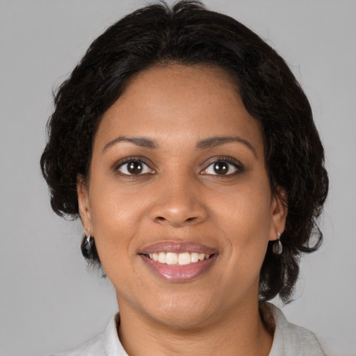 Joyful black young-adult female with medium  brown hair and brown eyes