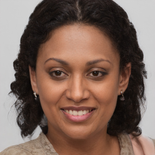 Joyful black adult female with medium  brown hair and brown eyes