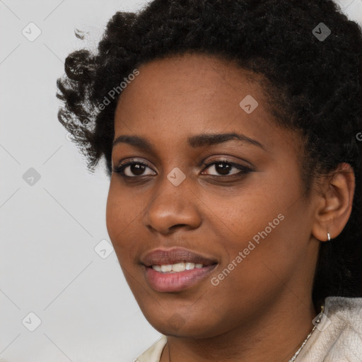 Joyful black young-adult female with short  black hair and brown eyes