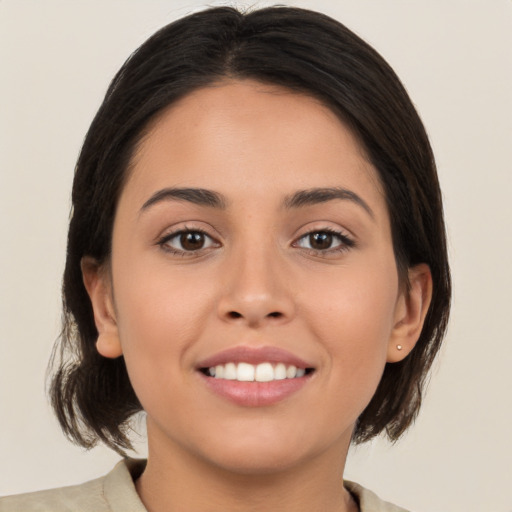 Joyful white young-adult female with medium  brown hair and brown eyes