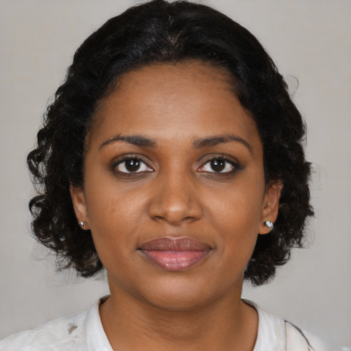 Joyful black young-adult female with medium  brown hair and brown eyes