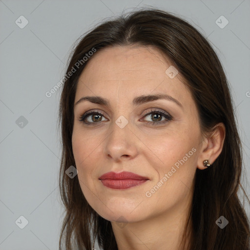 Joyful white adult female with long  brown hair and brown eyes